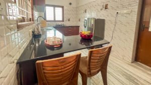 Fully equipped modular kitchen with refrigerator and utensils at Vasantha’s Home Stay by Le Hotel Host in Thillainagar, Trichy