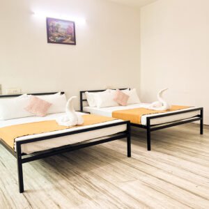 Spacious bedroom with two queen beds at Vasantha’s Home Stay by Le Hotel Host in Thillainagar, Trichy