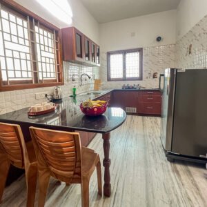 Fully equipped modular kitchen with refrigerator and utensils at Vasantha’s Home Stay by Le Hotel Host in Thillainagar, Trichy